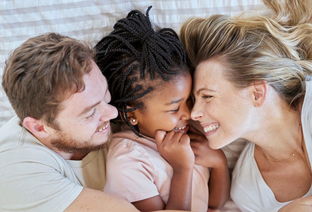 Family, interracial and love, happy and together with adoption or foster care overhead and bonding