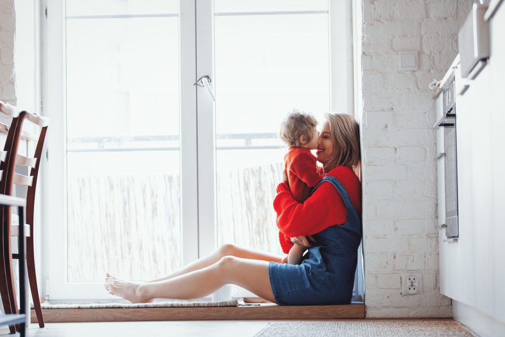 girl with a toddler boy is sitting at the threshold